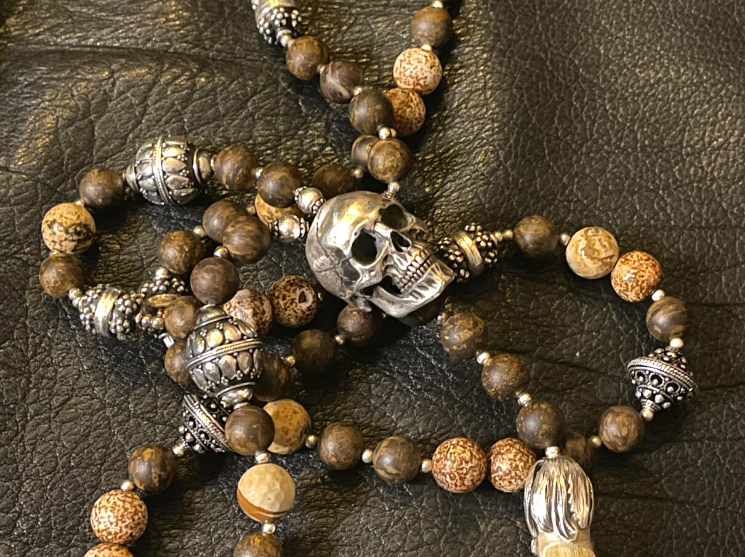 White stone skull beads necklace mala on rocky background Stock Photo -  Alamy